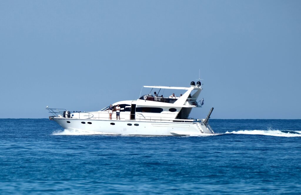 A sleek white yacht cruising in the blue sea near Parga, Greece.